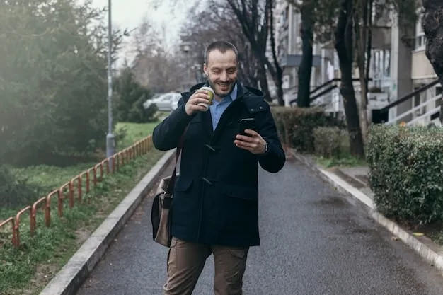 A person walking briskly and confidently on a well-lit street, looking around attentively with a determined expression. A smartphone is visible in their hand, with a safety app open.