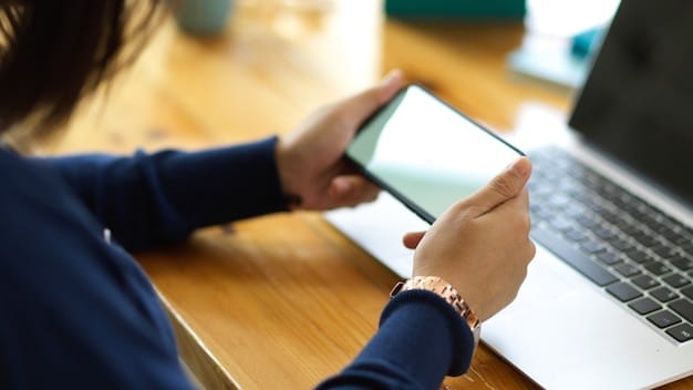 A person using a multi-factor authentication app on their smartphone, with blurred background showing online banking access on a laptop, illustrating the importance of two-factor authentication.