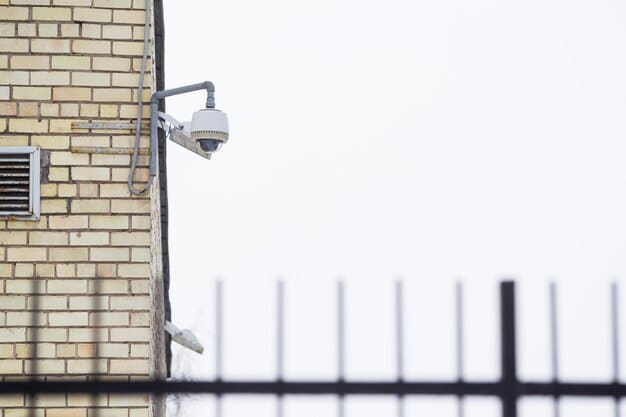 A close-up of a security camera mounted on a building, with a blurred background of a residential street.
